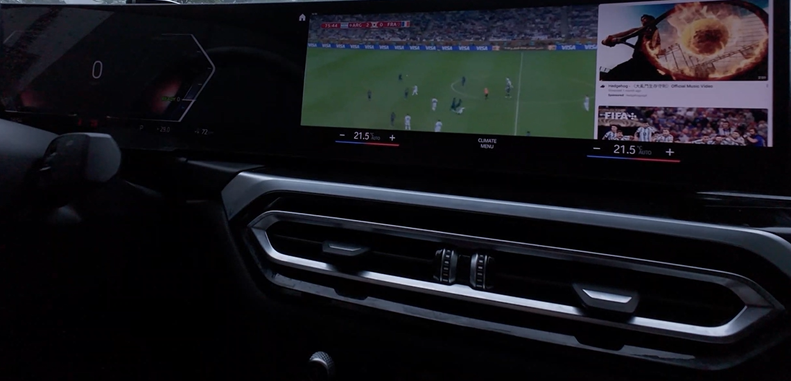 The World Cup match on the car screen, watched from the parked car